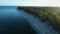 Ocean beach with coconut palms and sunrise sunshine. Aerial view of tropical coastline on Fuvahmulah island