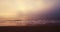 Ocean beach and foggy sunrise 4k video  waves splash on the sea sand