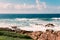 Ocean beach in Margate, SA, blue sky, white clouds, turquoise waves, rocks
