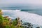 Ocean with big waves and surfers in Bali, Padang Padang