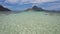 Ocean blue lagoon with moving ripple water with banca boats in front of epic Cadlao Island. Palawan, Philippines