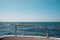 Ocean and blue sky / sea view horizon behind boat railing