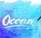 Ocean calligraphy sign on blue watercolor