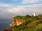 Ocean Cliffs With a White Lighthouse