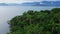 Ocean coastline with tropical forest, mountains and cloudy sky in Florianopolis, Brazil