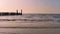 The ocean of domburg during sunset, wooden wave breaker poles with seagulls, Dutch beach scenery, nature background video