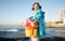 Ocean, fishing and portrait of girl with smile sitting on dock, fun and happy day at beach holiday on the weekend