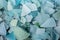 Ocean glass patterns on backgrounds with hands holding and grabbing, blues, whites, brown, green. Crafts