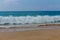 Ocean high tide waves on sandy beach