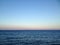 Ocean horizon with clear sky and moon at sunset