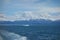 Ocean, iceberg, mountains and clouds.