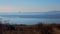 The ocean merges with the sky. Winter. Naked beach. Blue ice of the sea.