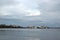 Ocean passenger shipping vessels anchored at sea port shore under cloudy skies