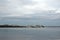 Ocean passenger shipping vessels anchored at sea port shore under cloudy skies