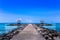 Ocean pathway at Candidasa Beach leading to a big love heart and two Balinese Pagodas with a clear blue sky in Bali, Indonesia