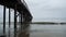 Ocean pier and gentle waves on a gloomy day