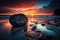 Ocean rocks on the beach and a vivid sunset sky with clouds