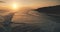 Ocean seascape at sunset light, cliff coast silhouette aerial view. Dark rock sea shore, sand beach