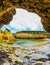 Ocean seaweed. Coastal arch of sandstone