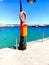 Ocean shore, pier, orange life buoy