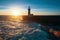 Ocean surf on the Atlantic coast, near lighthouse during a beautiful sunset, Porto