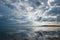 Ocean view and clouds reflection in the water in Gili Air Island