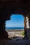 Ocean view from a hole in a brick wall