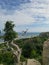 An ocean view with the old half-bald clumsy tree and the huge stone