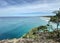 Ocean views and a surf beach taken from a rocky headland on a tropical island paradise off Queensland, Australia