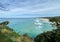 Ocean views and a surf beach taken from a rocky headland on a tropical island paradise off Queensland, Australia