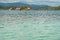 Ocean water texture closeup with island and wooden houses background - Guna Yala, San Blas Islands