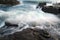 Ocean Wave crashing over multiple rock outcrops