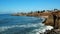 Ocean wave crushing on shore rocks from above aerial