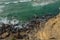 Ocean waves approaching rocky shore. Top view