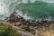 Ocean waves approaching rocky shore. Top view