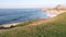 Ocean waves on beach, eroded cliff or bluff, La Jolla, California coast, USA.