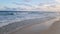 Ocean waves on a beach under summer sunset