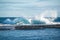 Ocean waves crashing on icebergs, black sand beach at Jokulsarlon, Iceland