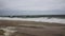 Ocean waves crashing onto beach leaving sea foam with a storm off the shore of Long Island New York