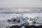 Ocean waves flow around chunks of ice on an Iceland Beach