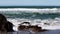 Ocean Waves Hitting Rocks On Sandy Beach Surfer In Background