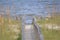 The ocean waves are just ahead at the end of the long boardwalk