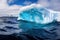 ocean waves lapping against the base of a colossal iceberg