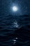Ocean waves and moon and stars at night.