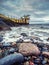 Ocean waves and rocks by Blackrock diving tower, Salthill area, Galway city, Ireland. Popular city landmark and tourist viewpoint