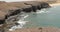 Ocean waves on rocky coast with black sand of Papagayo beaches on the island of Lanzarote, Canary Islands, Spain