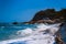 Ocean waves roll over a narrow strip of sandy beach in Lamai, Koh Samui, Thailand. A deserted part of Paradise beach.