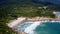 Ocean waves roll on sandy beach in lagune between rocks