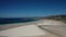 Ocean waves, sandy beach with people walking along the shore, Carnota beach, Galicia, Spain