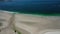 Ocean waves, sandy beach with people walking along the shore, Carnota beach, Galicia, Spain